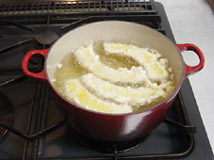 Frying dipped white fish.